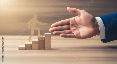 Wooden figure ascends stacked blocks toward a large outstretched hand symbolizing mentorship guidance career growth and opportunity on a wooden surface