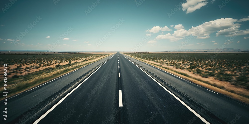 Fototapeta premium Aerial perspective of an empty highway with black asphalt and white lane markings, suitable for transportation planning or map design