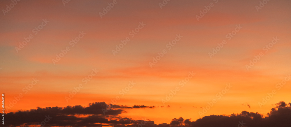Fototapeta premium Dramatic sunset sky with clouds. Evening sky colors.