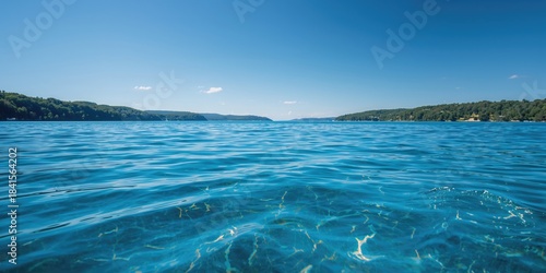 Fototapeta Naklejka Na Ścianę i Meble -  Scenic lake with vibrant blue waters serving as a backdrop for landscape photography, Earth Day