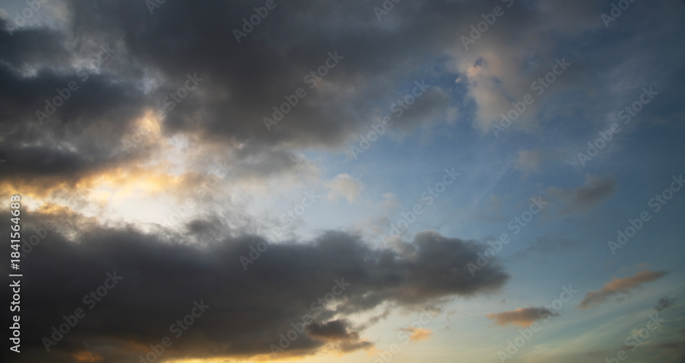 Fototapeta premium Dramatic sunset sky with clouds. Evening sky colors.
