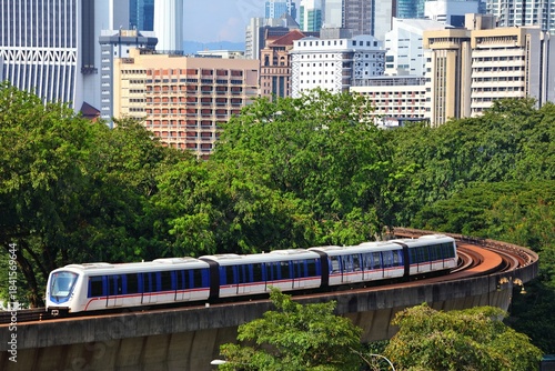 Photography Kuala Lumpur city view with light rapid transit public transportation train on elevated railway tracks
