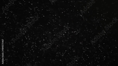 3d handmade render. Seamless footage, Professional VFX Snowfall Overlay Loop. Endless High-Quality Realistic Falling white translucent Dust Particles on a black background.