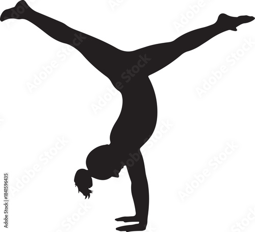 Silhouette of a female gymnast performing a handstand with legs spread wide