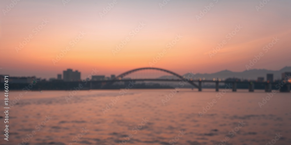Naklejka premium Banpo Bridge in Seoul, South Korea with blurred sky bokeh during sunset, urban infrastructure at dusk