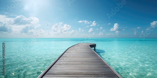 Fototapeta Naklejka Na Ścianę i Meble -  Weathered wooden platform by the vibrant blue sea with surf and sky, emphasizing vacation leisure, World Oceans Day