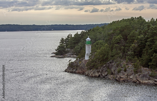 A lighthouse on a rocky cliff. Fairway between the islands of the Stockholm archipelago, Sweden.
