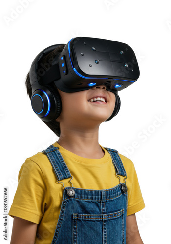 young east asian boy (7) in yellow shirt and denim overalls wearing a futuristic black vr headset, mouth parted in awe, looking up in pure joy. white studio background with copy space. concept of