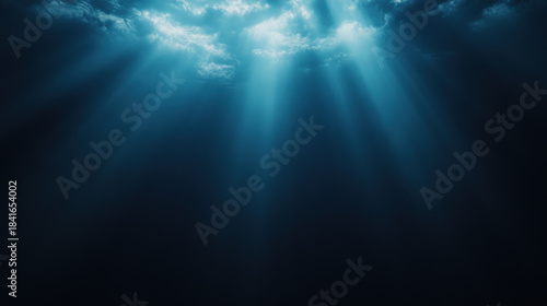 Mysterious underwater scene with beams of light illuminating dark ocean depths