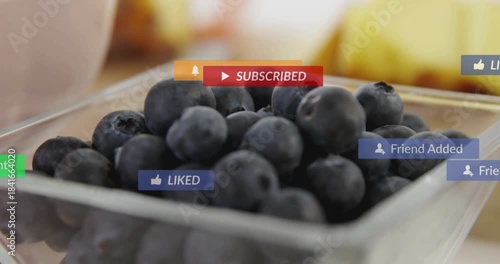 Mouse clicking badges popping and drifting over square jar of blueberries showing engagement