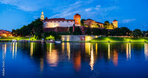 Twilight skyline of Wawel Castle and Wawel Cathedral on the shores of river Vistula in Krakow, Lesser Poland, Poland