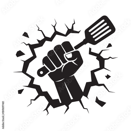 A clenched fist breaking through cracked surface powerfully gripping a kitchen spatula