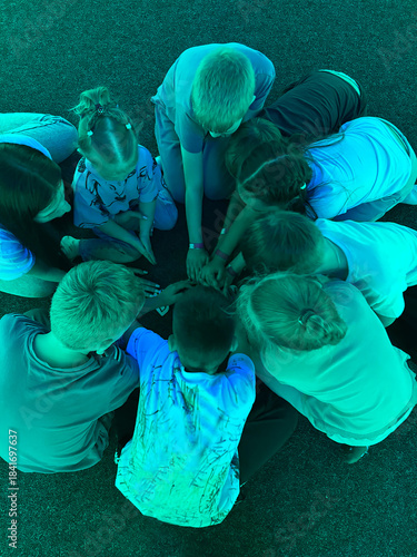 Children forming a circle with hands together unity concept