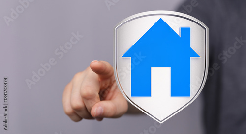 A finger touching a house i...