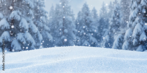 Softly falling snow covers ground, blurred pine forest background, peaceful winter landscape