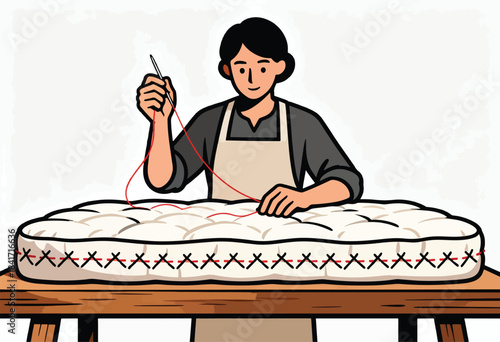 A person in an apron stitches a mattress with red thread and a needle