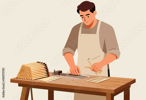 A person in an apron carefully crafts wooden matchsticks on a workbench