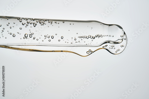 Cosmetic pipette dispensing serum with liquid bubbles