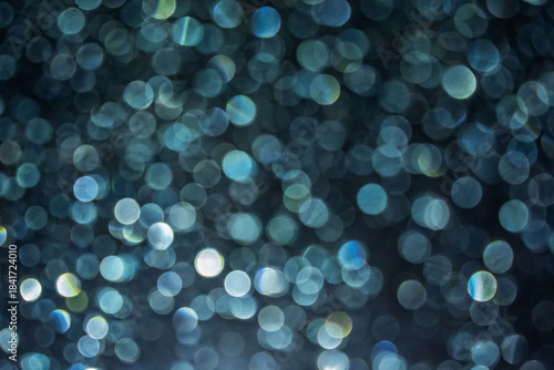 Soft focus image of bokeh effect over grass. the background at night time for overlay design, suitable for text and layout purposes