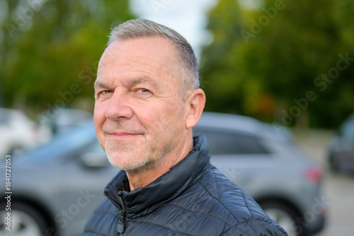 Mature Man Smiling Outdoors Calmly