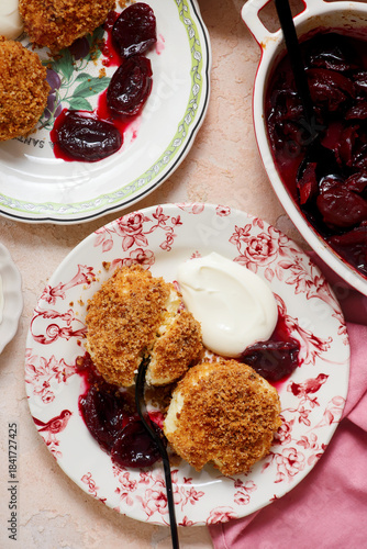 Traditional Austrian cottage cheese dumplings in breadcrumbs with plum compote and sour cream.