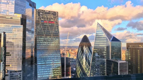 London,: Modern skyscrapers of the City of London, international financial area. Sunset reflections in windows. 