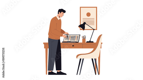 Man working on his desk with illustrations on a laptop in a cozy home office setting