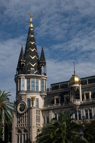 Ornate architectural facade with golden statue and decorative clock, Batumi, Georgia