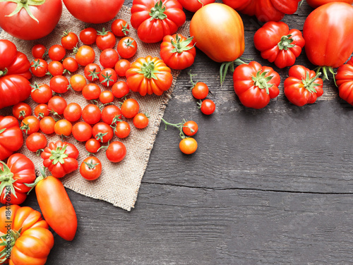 Fresh Ripe Tomatoes and Cherry Tomatoes on Rustic Wooden Background