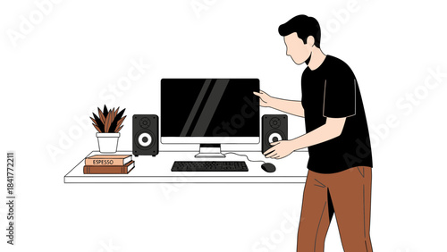 A man setting up a desktop computer with speakers and accessories on a desk