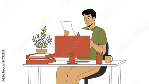A man working at a desk reviewing documents and working on a computer illustration