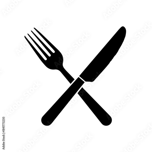 Isolated shiny silver fork, knife, and spoon dining cutlery set on a white table