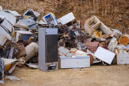 Abandoned and broken appliances in a junk yard setting