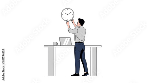 A man hanging a clock on the wall above a desk with a laptop and a mug in an office