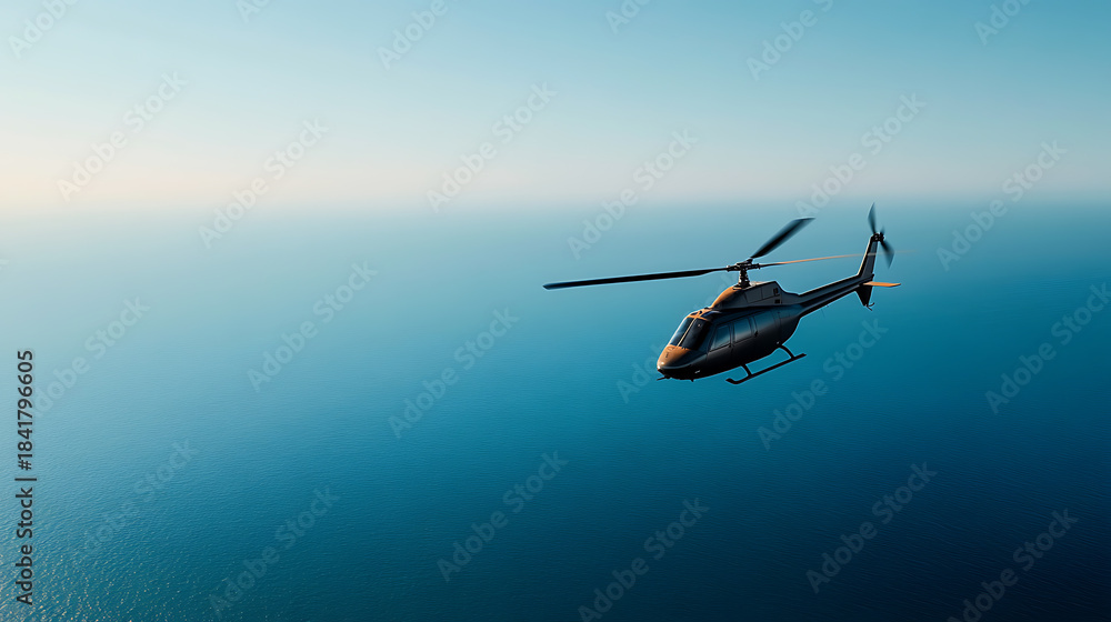 Fototapeta premium A helicopter soars gracefully over a calm, endless expanse of blue ocean. The sky is clear, creating a picturesque view of transportation, and freedom. A smooth flight.