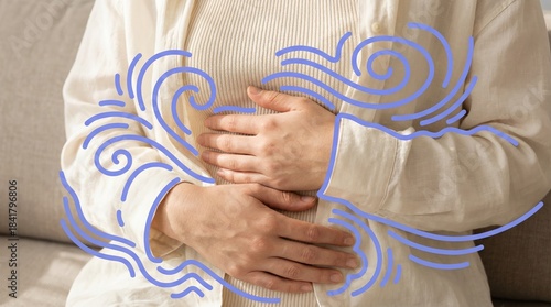 Person in beige clothes holding stomach with blue graphic swirl lines