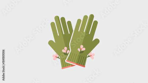 A pair of green gardening gloves with delicate pink floral accents on a light gray background.