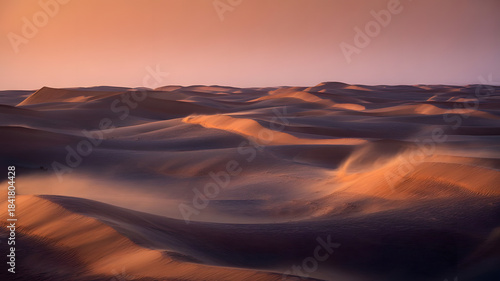 Fototapeta Naklejka Na Ścianę i Meble -  A serene landscape of rolling sand dunes bathed in the warm soft hues of a breathtaking sunset creating a peaceful view
