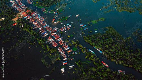 Kampong Phluk floating village with stilt houses on Tonle Sap lake in Cambodia.