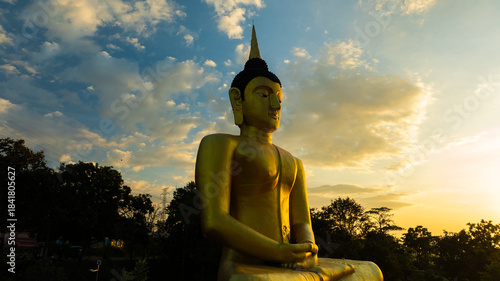 Aerial view at sunset above the Mekong river in Laos revealing Pakse city golden giant buddha