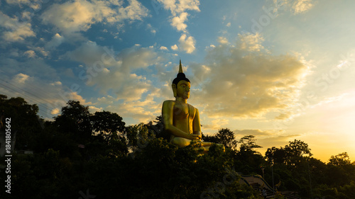 Aerial view at sunset above the Mekong river in Laos revealing Pakse city golden giant buddha