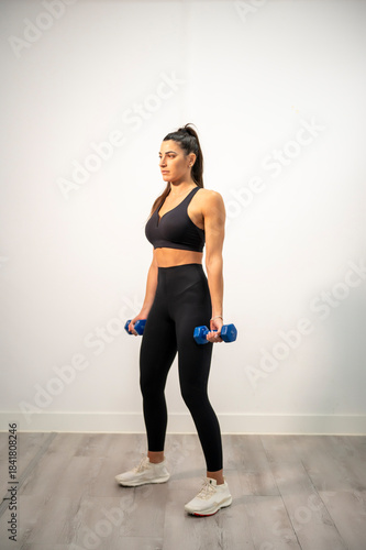 Woman holding dumbbells preparing for strength training workout