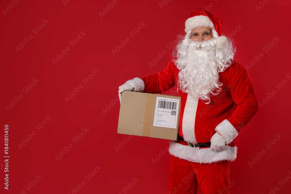 Naklejka premium Santa Claus with parcel on red background, space for text