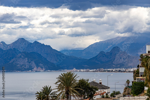 Fototapeta Naklejka Na Ścianę i Meble -  Panoramic view of Antalya Bay with the dramatic Taurus Mountains towering over the tiny coastal houses of Konyaaltı. Antalya, Turkey, Mediterranean.