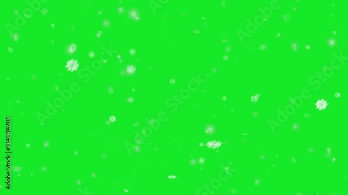 Snowflakes falling on a green screen background for video and film projects. snowfall overlay