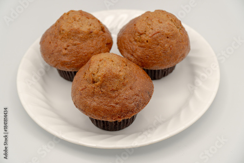 Carrot muffins on a white plate (selective focus)