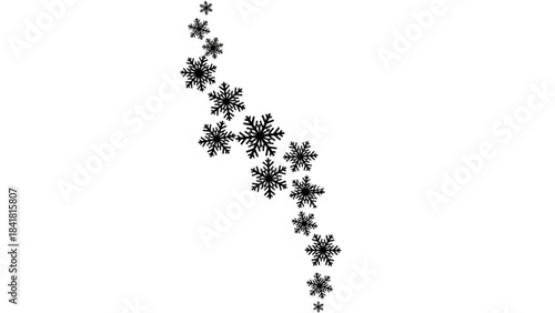 A group of black snowflakes falling down on in a diagonal line