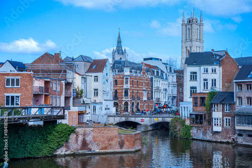 Wallpaper Mural Historic towers and charming facades rise above the winding Ghent canal, where brick homes, arched bridges, and lively streets create a vibrant blend of old and modern city life. Torontodigital.ca
