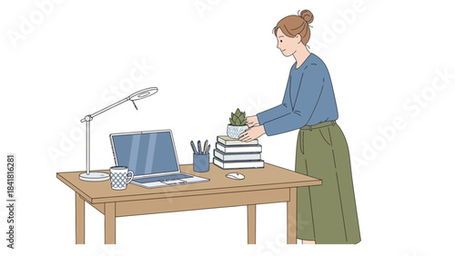 Woman at desk organizing a workspace with a laptop, plant, and books setting
