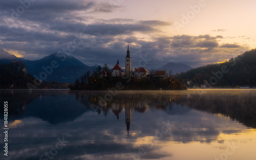 Lake Bled during a fiery, misty sunrise in autumn